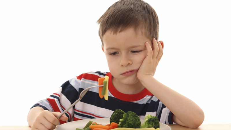 boy and cooked vegetables