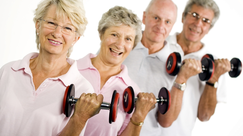 Mature older people lifting weights