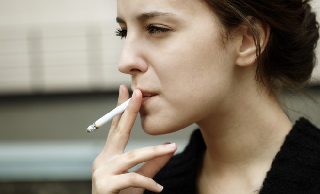 young-woman-smoking-cigarette_63799780-660x400